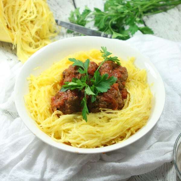 These giant-sized Paleo & Whole30 Italian Meatballs with Spaghetti Squash are tasty, healthy and easy to make in the slow cooker for a fuss-free dinner!