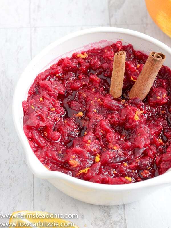 This Low Carb, Keto Cranberry Sauce has a citrus-cinnamon twist and is the perfect complement to your holiday spread. Fresh orange zest and orange extract replace the sugary orange juice found in most cranberry-orange sauces, and a monk fruit blend brings plenty of sweetness without all of those carbs. #farmsteadchic #cranberrysauce #ketocranberrysauce #lowcarbcranberrysauce #ketoholiday #lowcarbholiday #thanksgivingrecipes #Christmasrecipes #ketothanksgivingrecipes #ketoChristmasrecipes #lowcarbthanksgivingrecipes #lowcarbChristmasrecipes
